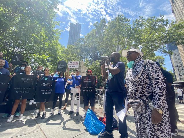 At a rally in front of City Hall earlier this month, protesters held signs with the names of incarcerated people who recently died at Rikers Island and called for a new city law to ban solitary confinement.